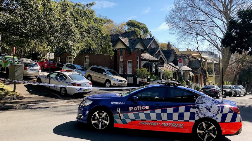 Several cars parked on a street.