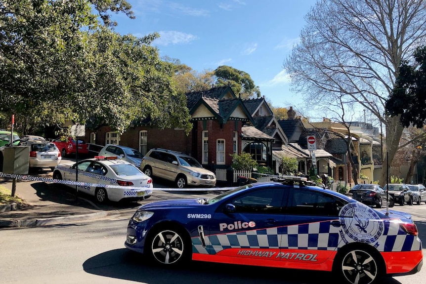 Several cars parked on a street.