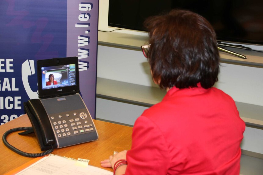 Acting director of Legal Aid Susie Winter demonstrates the new video phone