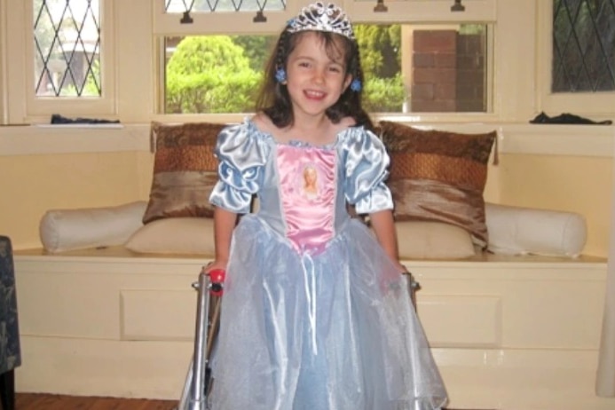 Hannah Diviney as a child, smiling in a princess costume and tiara.
