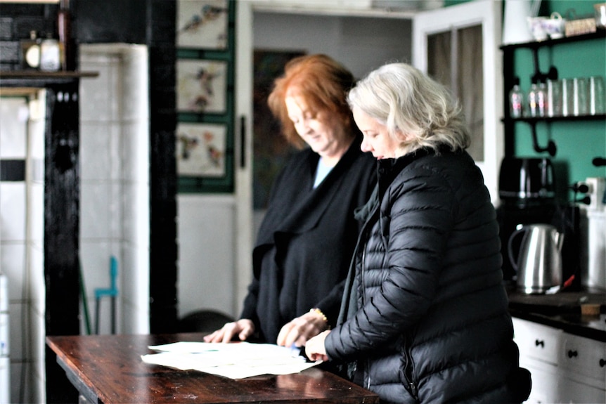 Andrea showing Jen McRae documents 