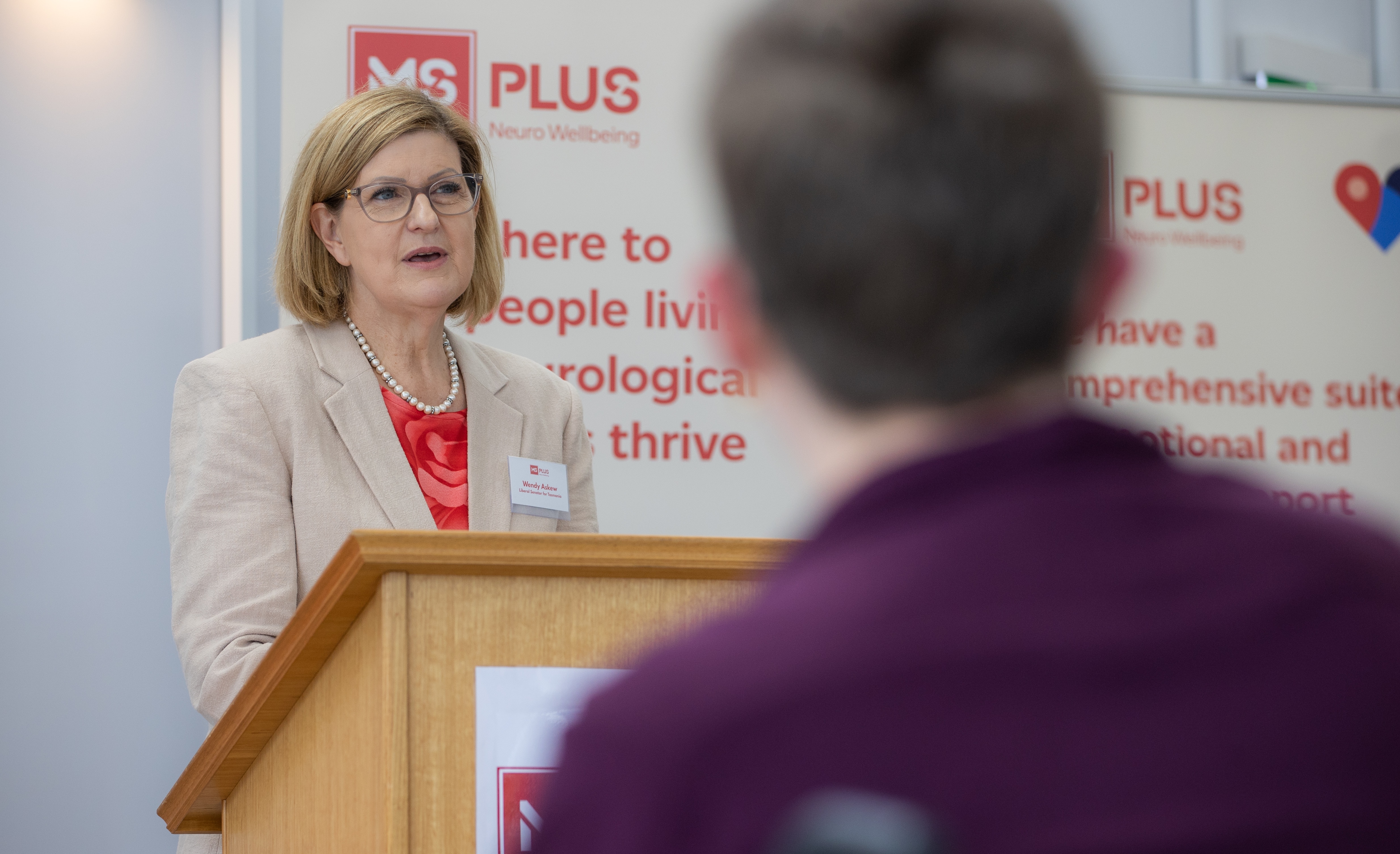 Senator Wendy Askew speaking at a lectern.