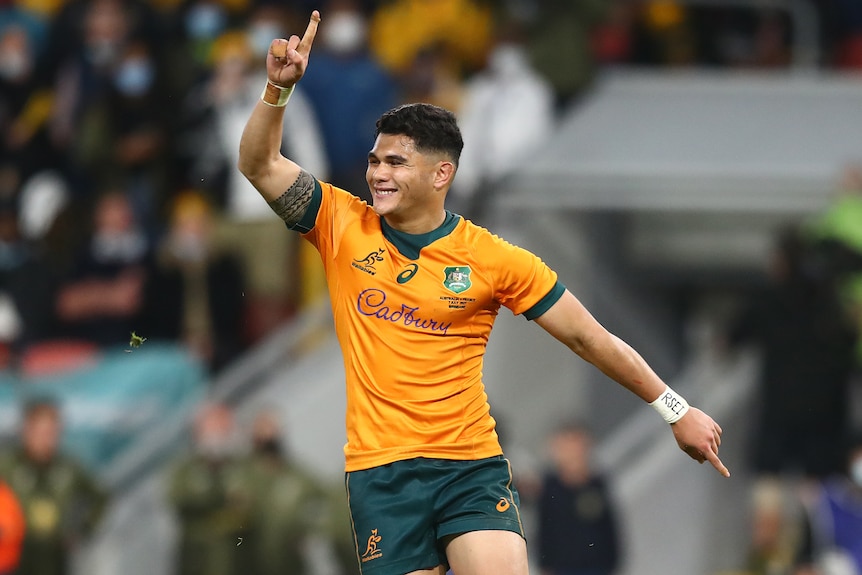 A Wallabies player raises a finger on his right hand as he celebrates kicking the winning penalty goal against France.