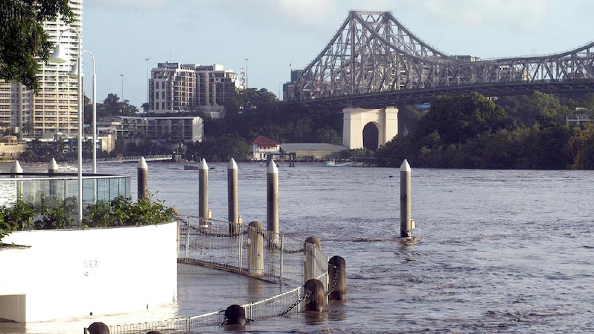 Flooded riverside walkway at Pier 9 in Brisbane's CBD