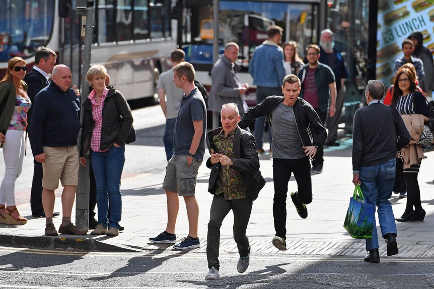Actors Ewan McGregor and Ewan Bremner run on the set of the Trainspotting film sequel on Princess Street Edinburgh, Scotland.