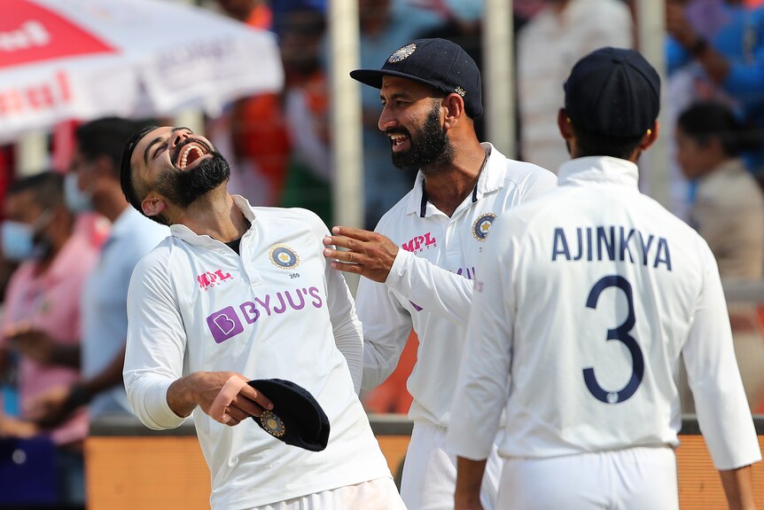 Virat Kohli leans back and laughs