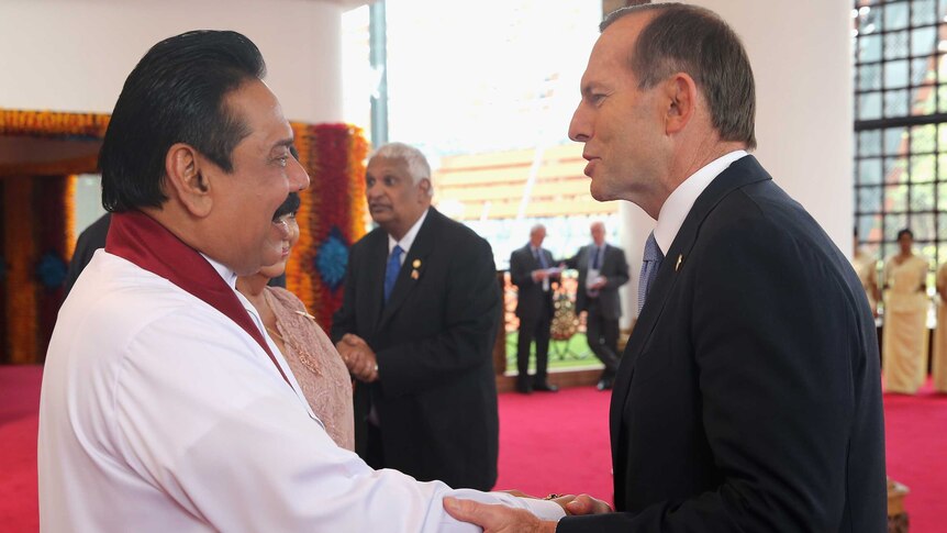 Tony Abbott greets Sri Lankan president Mahinda Rajapaksa in Colombo.