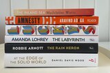 A stack of six books on the shortlist of the Miles Franklin Literary Award