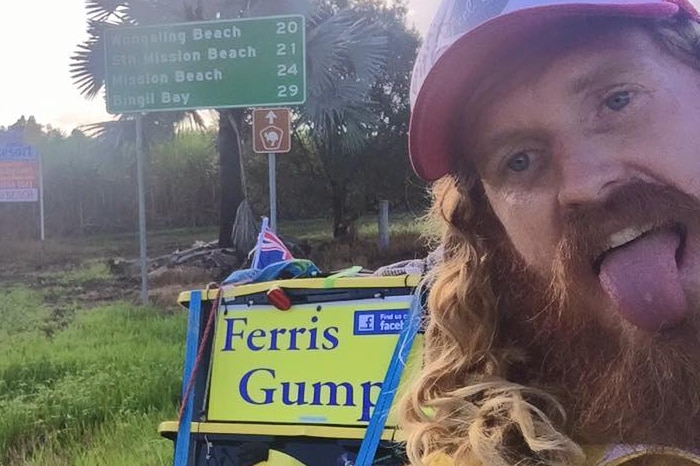 Ferris Gump poses for a photograph near a road sign in far north Queensland.