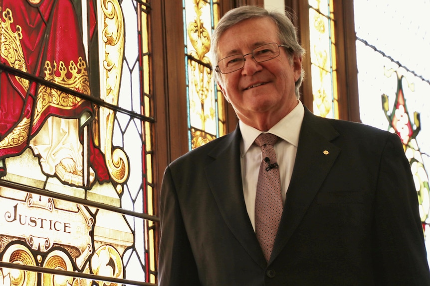 WA Chief Justice Wayne Martin stands beside a stained glass panel in the 114-year-old Supreme Court building in Perth.