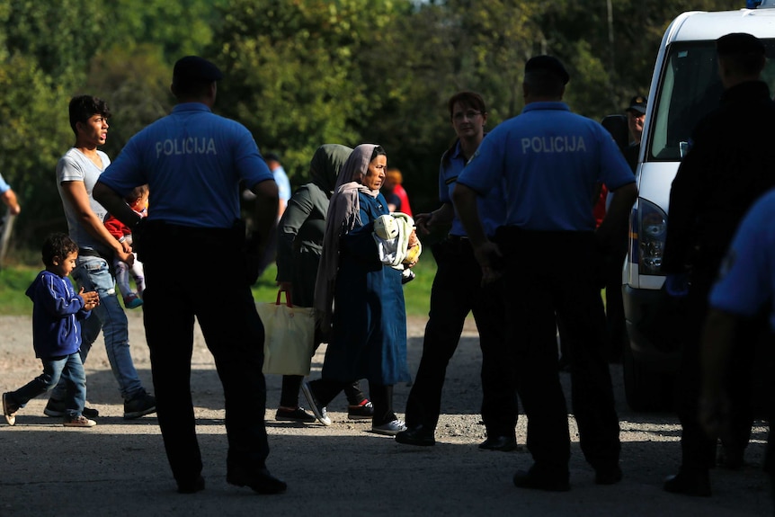 A group of migrants is escorted by Croatian police in Tovarnik, Croatia