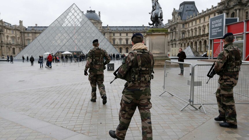 French soldiers patrol the Louvre