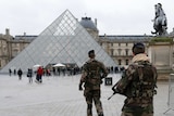 French soldiers patrol the Louvre