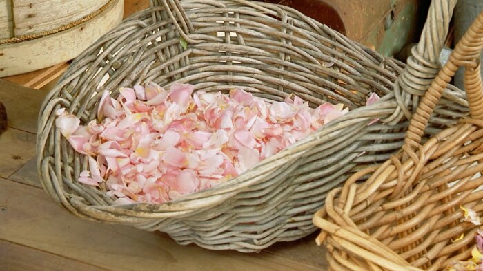 Pink petals in wicker basket