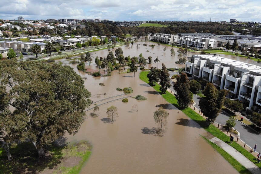 Flooding in parkland near an apartment complex.