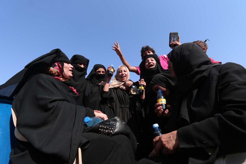 Civilians react after the liberation of Manbij