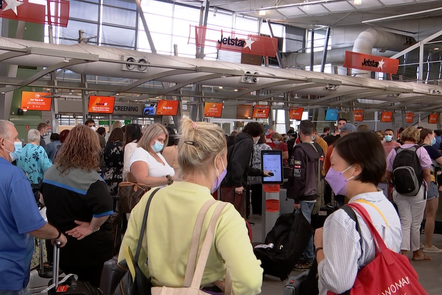 people waiting in lines at the airport