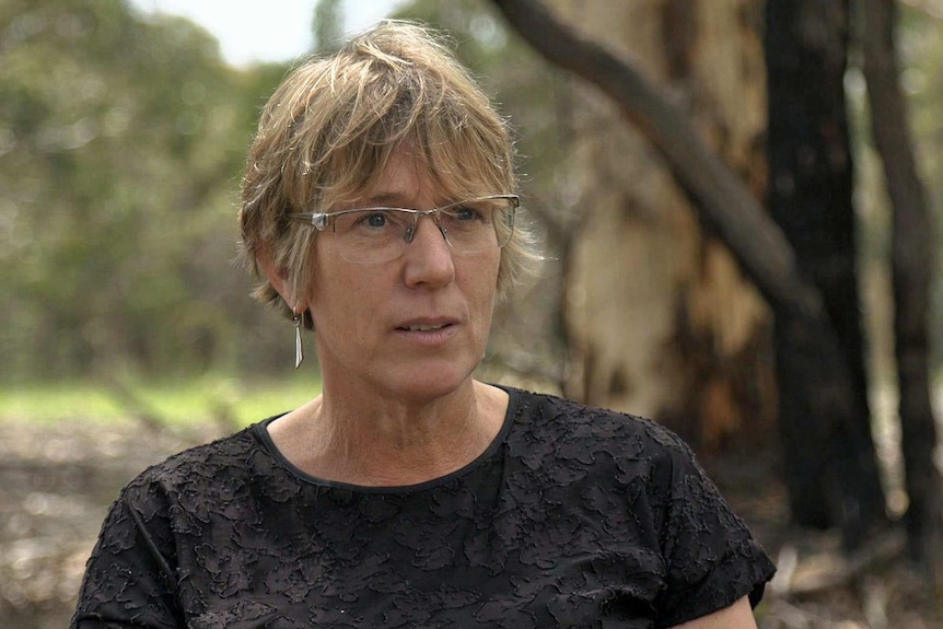 Clare Murphy wears glasses and a black top.