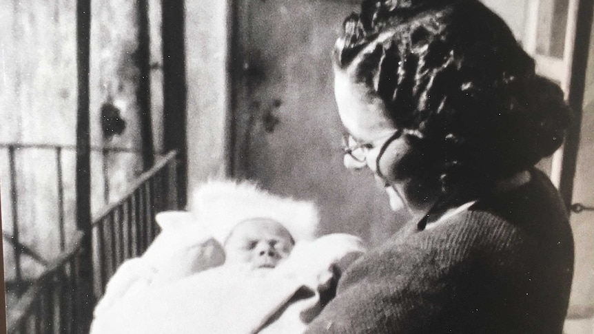 Black and white image of a grandmother holding Eva Temple as a young baby.
