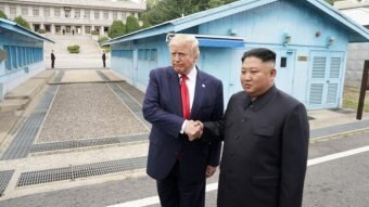US President Donald Trump meets with North Korean leader Kim Jong-un shaking hands.