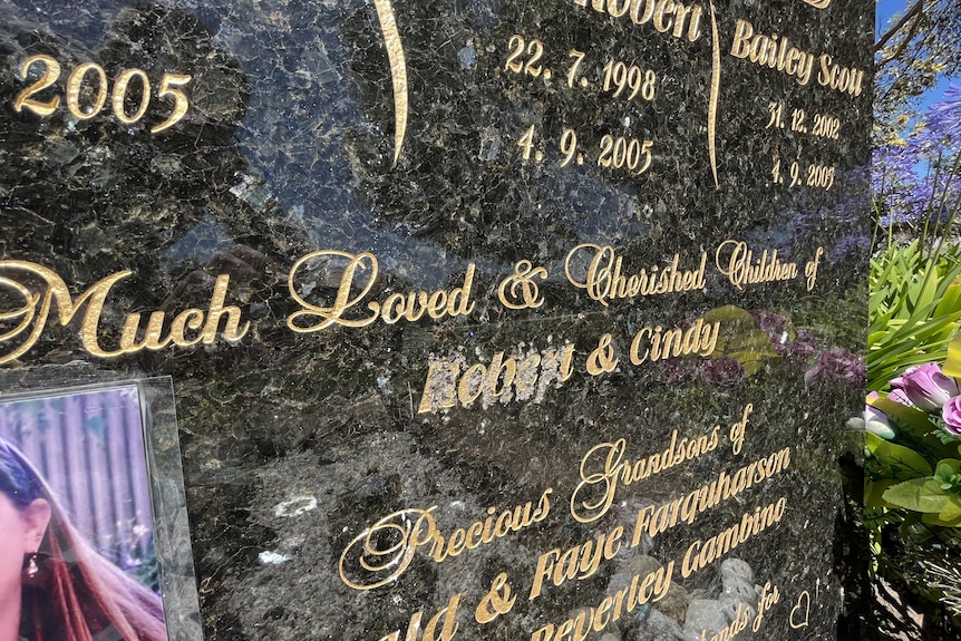 Scratching on Robert Farquharson's name on the family gravestone.