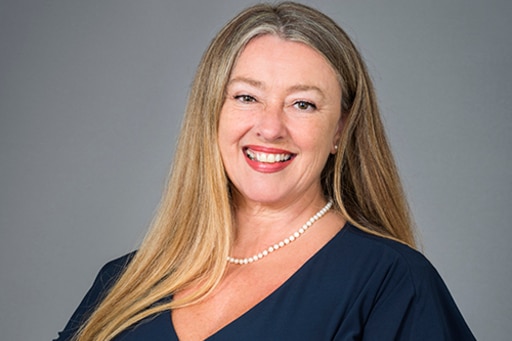 a woman with long hair smiling