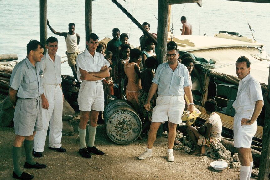 On the wharf at Losuia, Trobriand Islands, Milne Bay District. Stow is second from left.