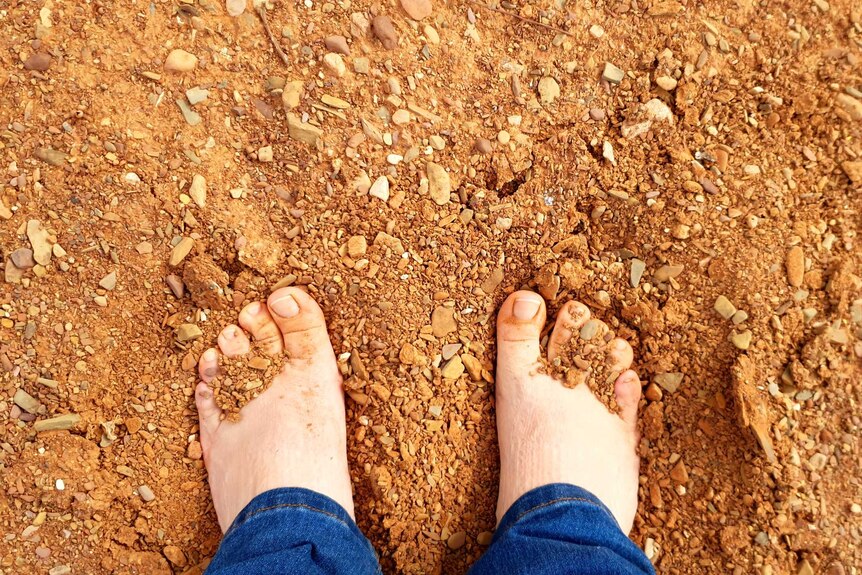 Brooke with her feet in the soft Sandy Creek bed in Ikara