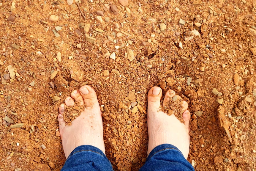 Brooke with her feet in the soft Sandy Creek bed in Ikara