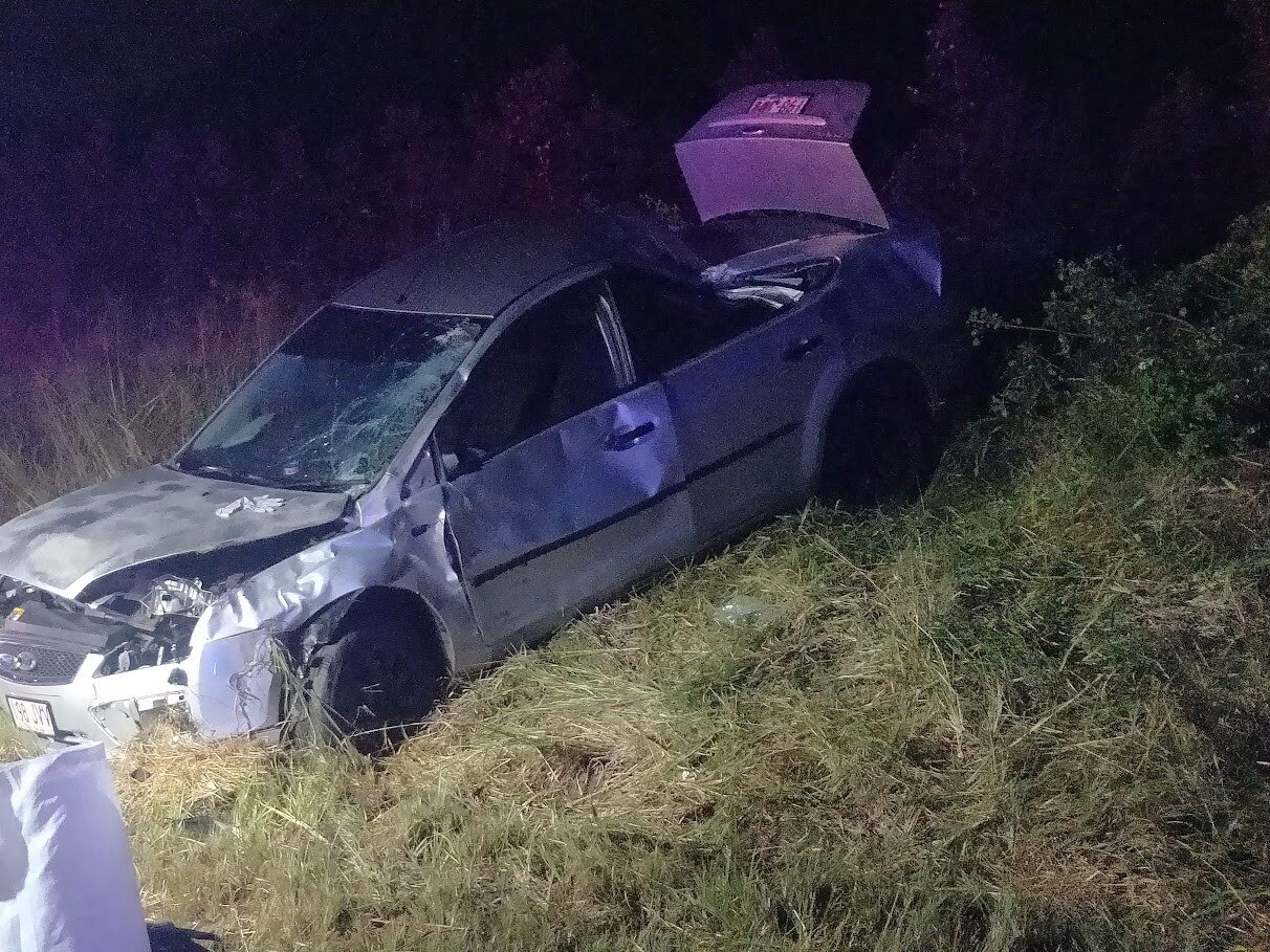 Car in a field after crash.