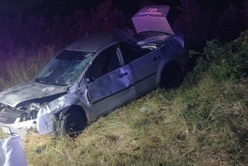 Car in a field after crash.