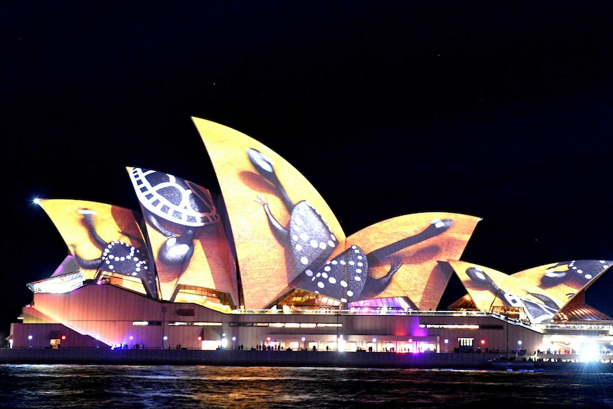 The sails of the Sydney Opera House are lit up with an art installation called Songlines.