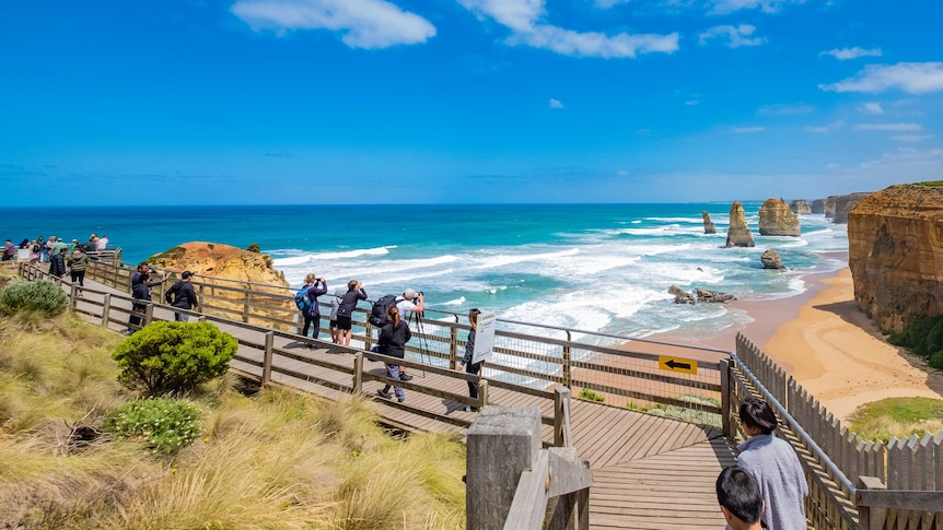 Tourists viewing and taking photos of the Twelve Apostles