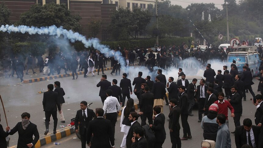 Police use tear gas to disperse angered lawyers storming a hospital.