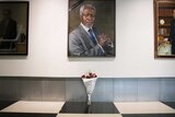 A black ribbon and a bouquet of flowers adorn the portrait of former UN secretary-general Kofi Annan at UN headquarters
