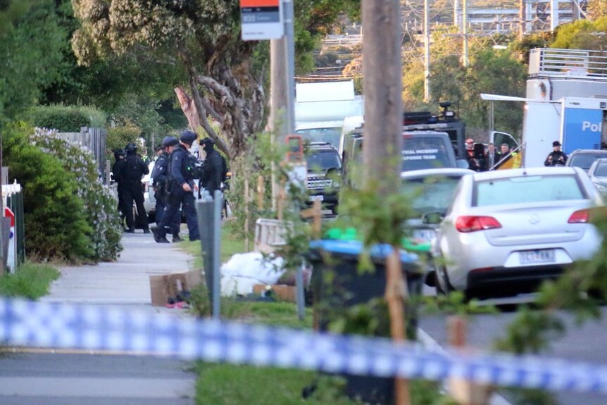 Police at a house where four people are being held in Frankston