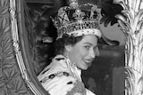 Queen Elizabeth II smiles through the window of a coach after her coronation in 1953.