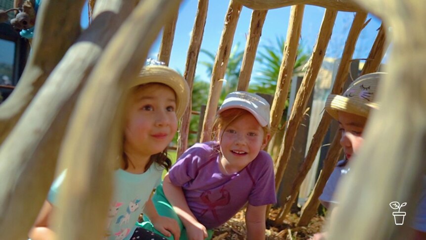 Kids inside a homemade stick cubbyhouse