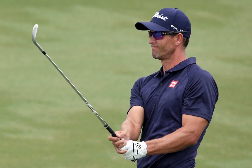 Adam Scott plays from the fairway during his third-round of 71.