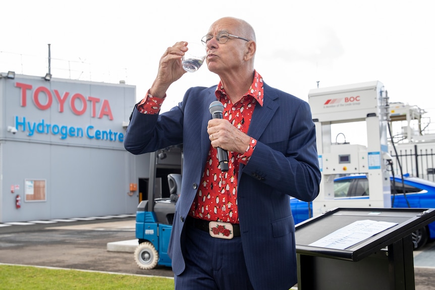 a man drinking a glass of water