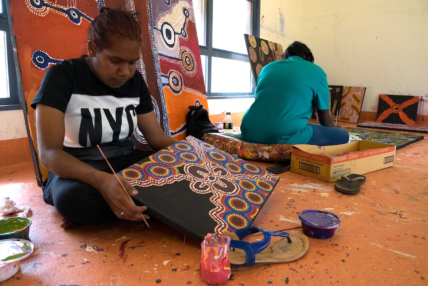 Indigenous artists paint in a workshop in the APY Lands.