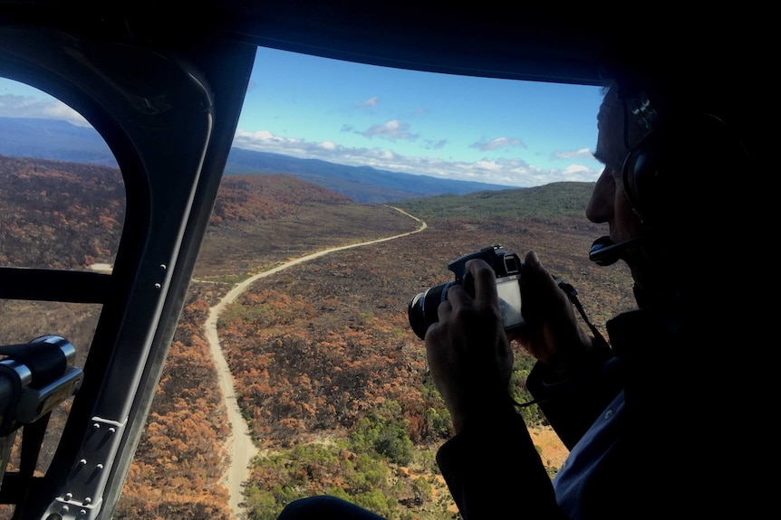 Senator Nick McKim views bushfire damage