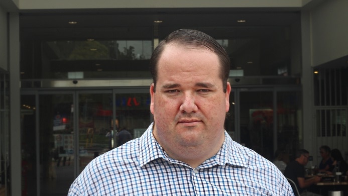 A man wearing a checked shirt.