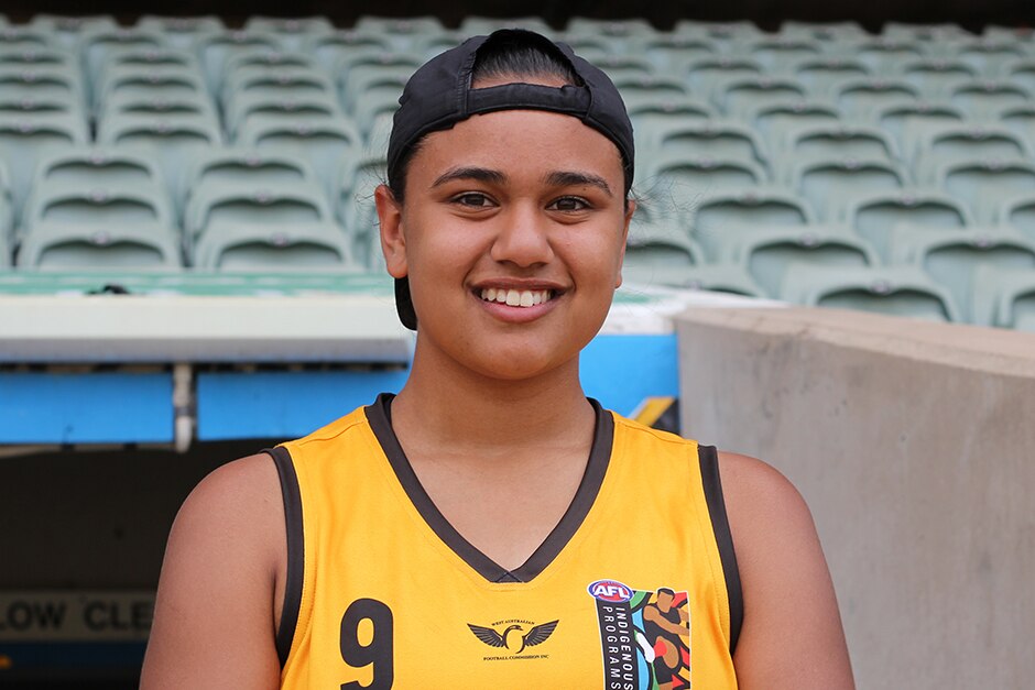 A girl in a football jersey.