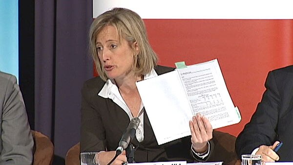 ACT Treasurer Katy Gallagher holds up papers at the Budget breakfast