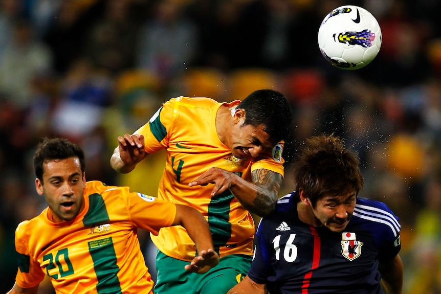 Battling hard ... Tim Cahill (C) says the Socceroos had to dig deep to draw with Japan.