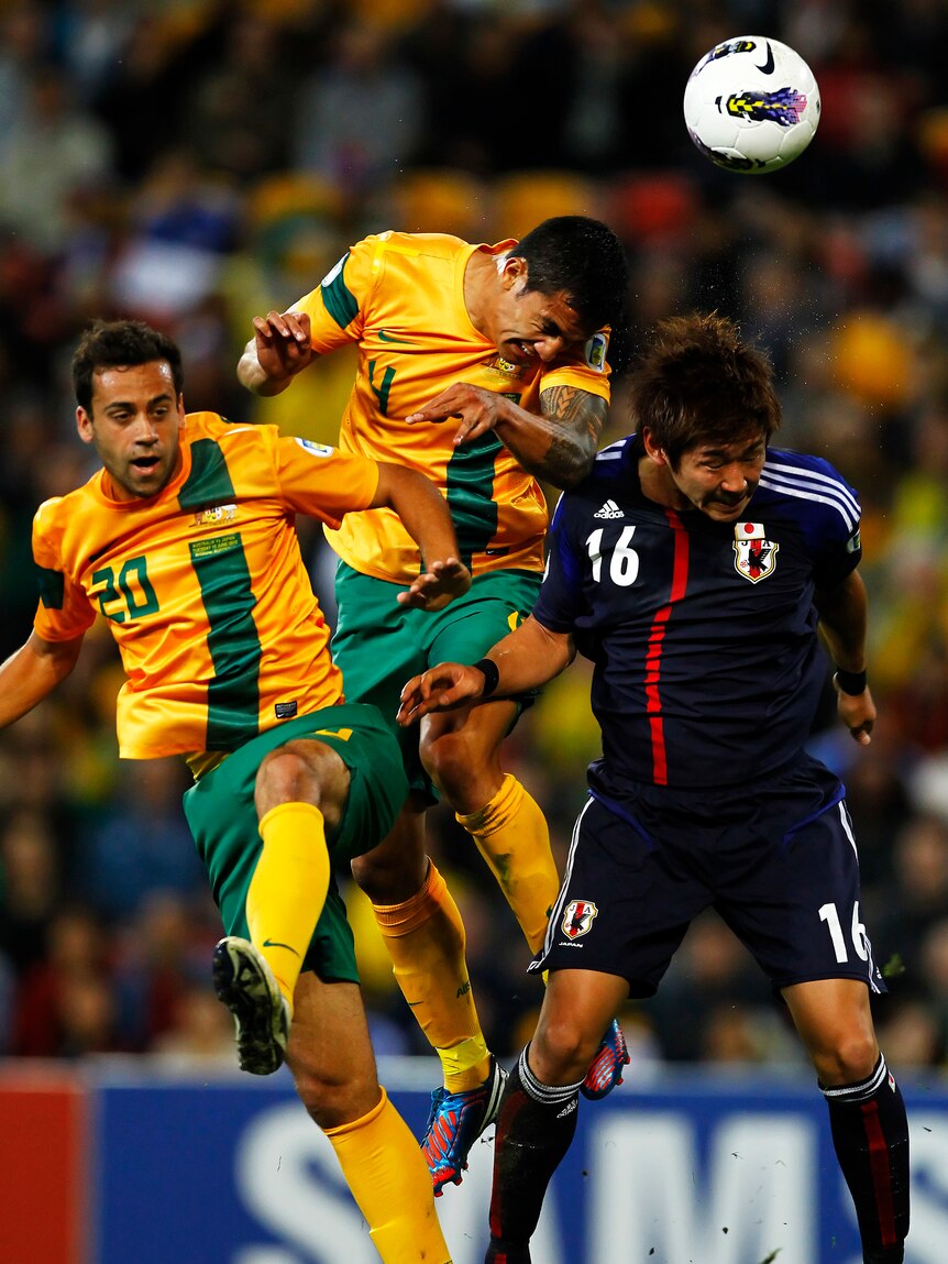 Battling hard ... Tim Cahill (C) says the Socceroos had to dig deep to draw with Japan.