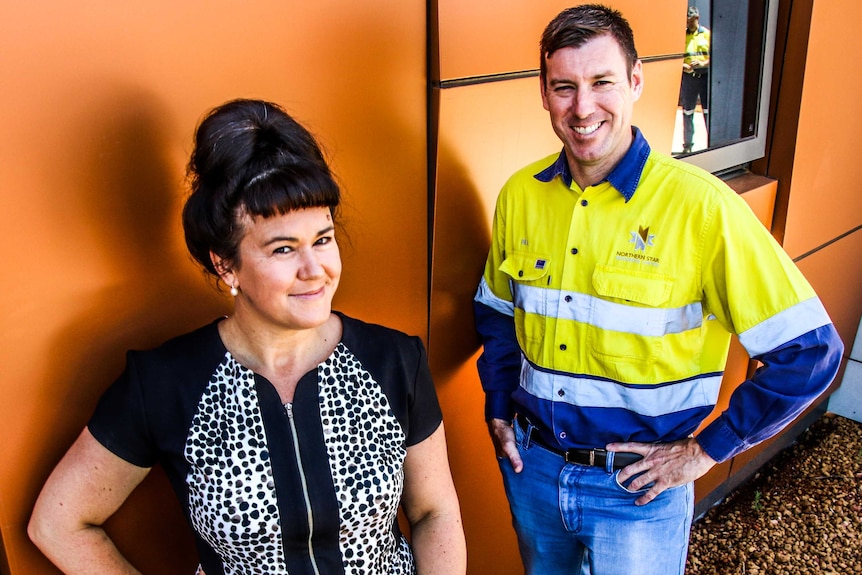 Two people stand in front of student accommodation in Kalgoorlie, Western Australia.