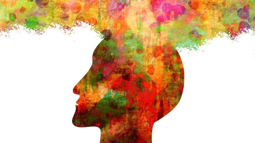 A silhouette of a head with bright colours and an aura above