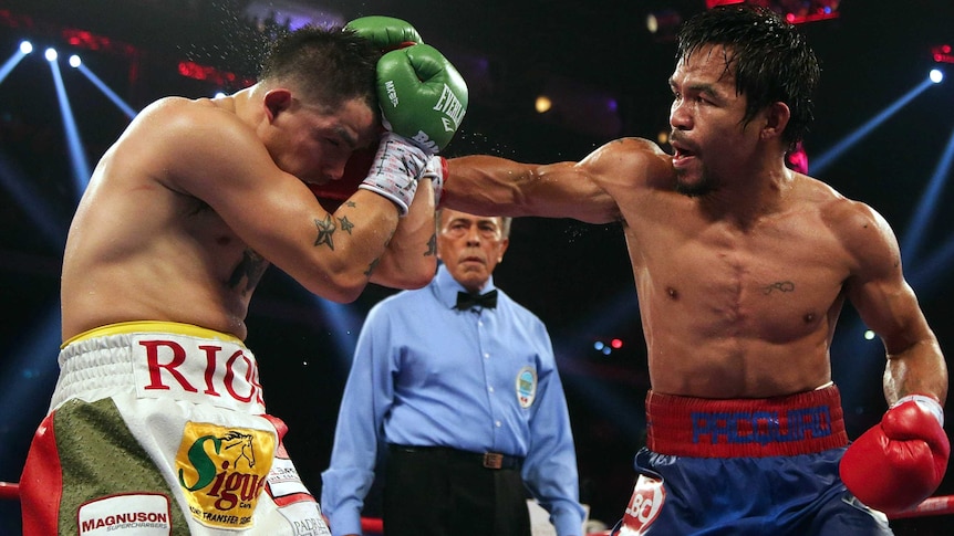 Manny Pacquiao (R) fights with Brandon Rios in their WBO welterweight title fight in Macau.